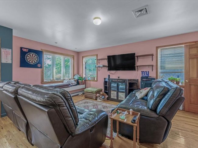 Living room featuring light wood-style floors | Image 16