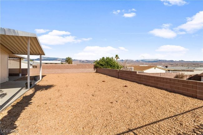 View of yard featuring a fenced backyard and a mountain view | Image 40