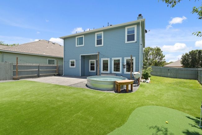 Rear view of property with a patio area, a hot tub, and a chimney | Image 5