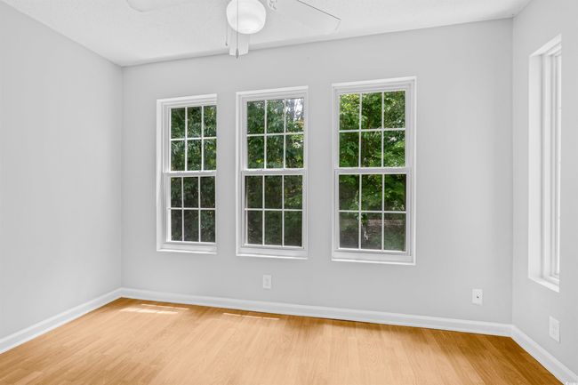 Spare room featuring a ceiling fan, plenty of natural light, and wood finished floors | Image 28