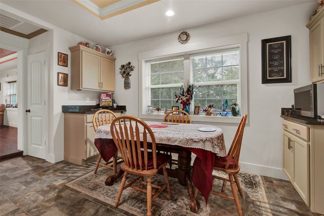 This kitchen nook has double windows as well as more counter space and cabinetry. | Image 13
