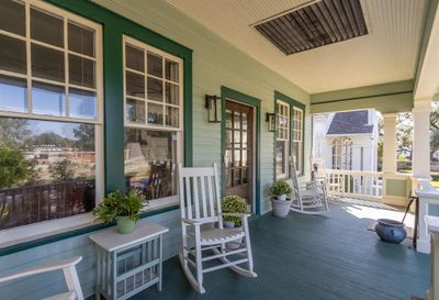 Front porch, 28x8, overlooking a beautiful esplanade. This is the Mardi Gras parade route and this raised porch provides an excellent viewing area. Craftsman-style features include the multi-paned upper sash windows over the solid glass panel. The four windows and front door give you an idea of the length of the living room right inside. | Image 3