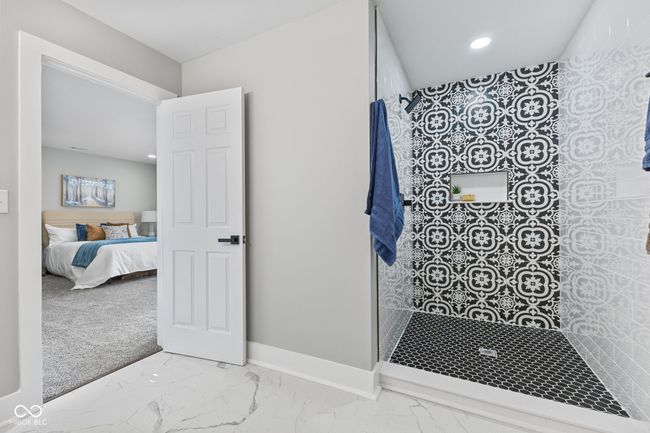 ensuite bathroom with marble finish floor, ensuite bath, baseboards, and tiled shower | Image 21