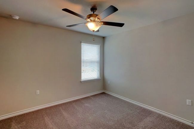 Carpeted empty room with baseboards and ceiling fan | Image 16