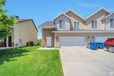 View of front of home featuring a front lawn and a garage | Image 1