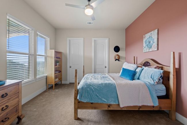 Bedroom with carpet floors, a ceiling fan, visible vents, and baseboards | Image 32