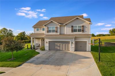 Craftsman house with a front lawn and a garage | Image 2