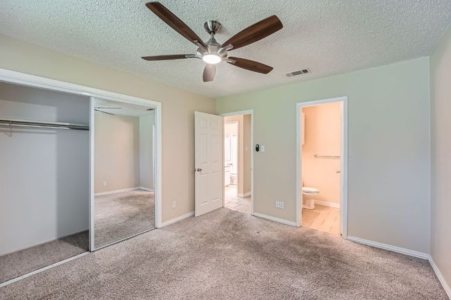 Spacious primary bedroom with a large mirrored closet. | Image 6