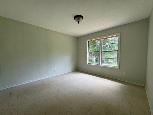 Spare room with baseboards and tile patterned floors | Image 9