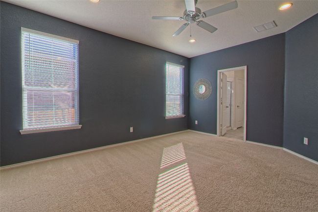 Empty room with carpet flooring, plenty of natural light, ceiling fan, and recessed lighting | Image 20