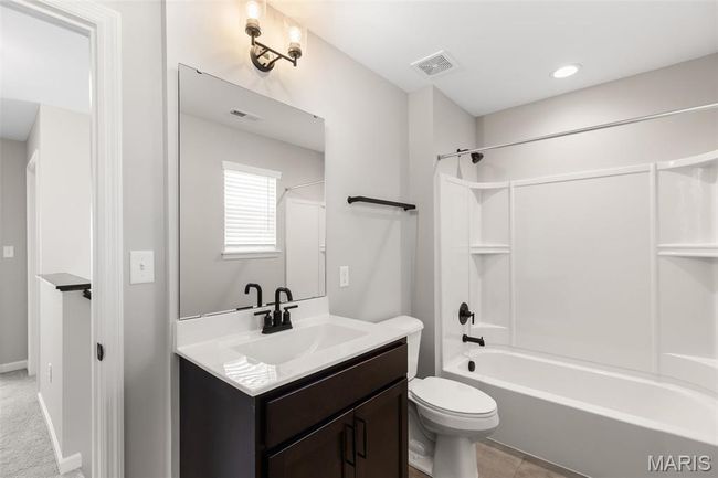 Full bath with vanity, bathtub / shower combination, and toilet | Image 15