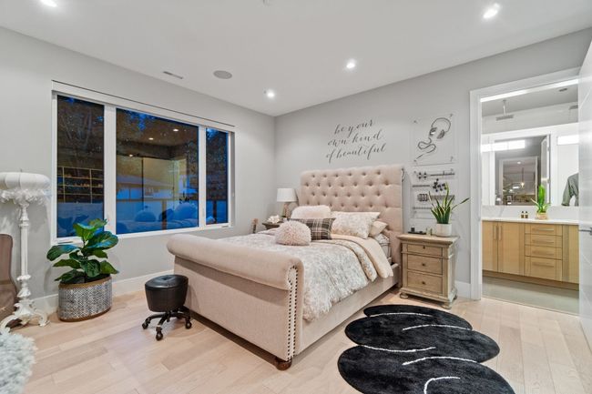 Bedroom featuring light wood finished floors, recessed lighting, and connected bathroom | Image 13