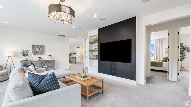 Living area featuring baseboards, visible vents, recessed lighting, a notable chandelier, and light colored carpet | Image 43