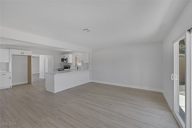 Unfurnished living room featuring light wood-style flooring | Image 17