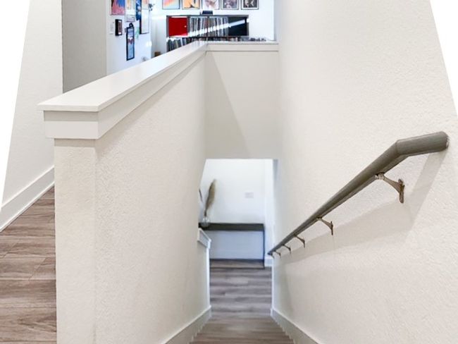 Stairs featuring baseboards and wood-look finished floors | Image 9