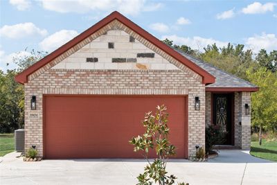 View of front of property with a garage and central AC | Image 2