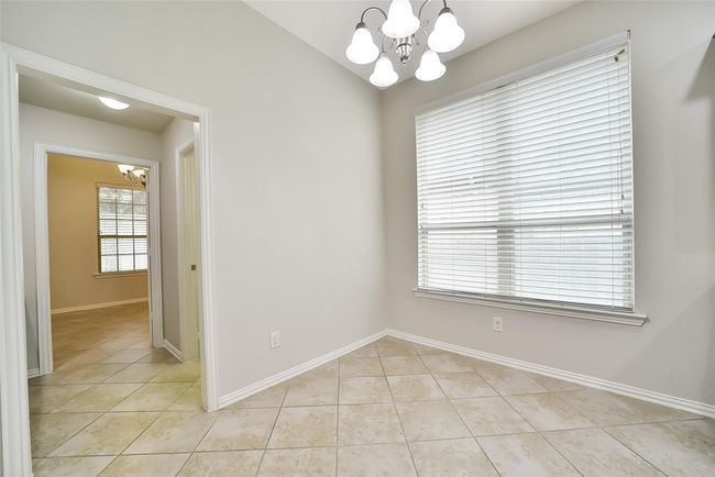 This sunny breakfast room is the perfect place to enjoy a casual meal with the family. Just beyond here you will find a bonus study space and walk-in pantry. | Image 9