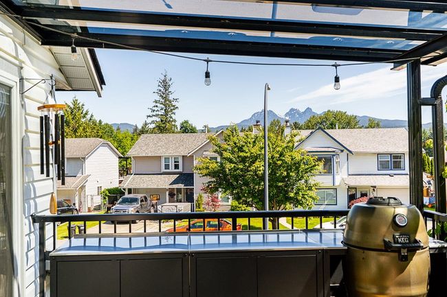 Balcony with a mountain view, grilling area, and a residential view | Image 17
