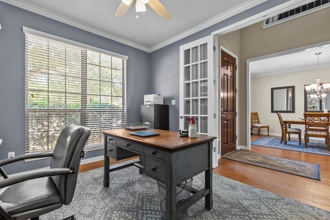The primary suite is conveniently located downstairs, while the rest of the layout unfolds like a dream—with wood, tile, and carpet underfoot and natural light pouring in from all directions. | Image 17
