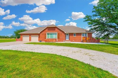 Ranch-style house featuring a garage and a front lawn | Image 2