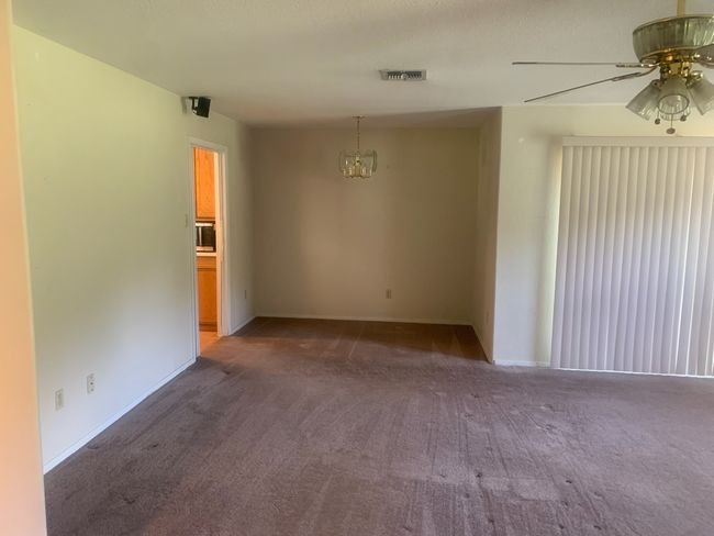 Dining area with carpet and a chandelier | Image 4