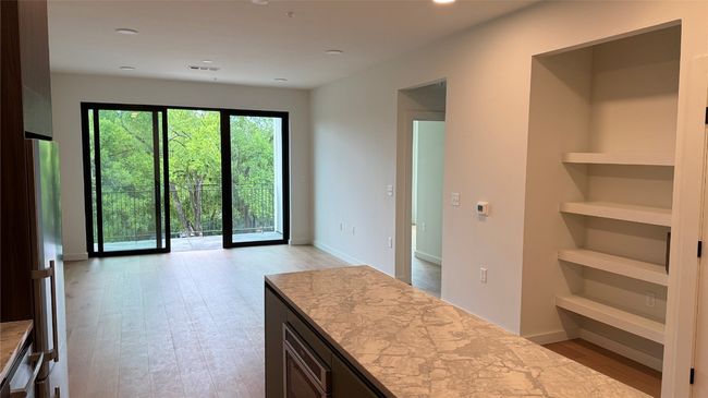 Kitchen with light wood-style floors, light countertops, recessed lighting, and open floor plan | Image 12