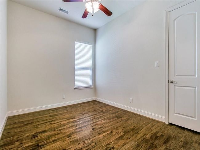 Empty room featuring ceiling fan, dark wood-style floors, and baseboards | Image 15