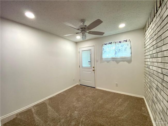 Doorway with recessed lighting, carpet, a ceiling fan, baseboards, and a textured ceiling | Image 12