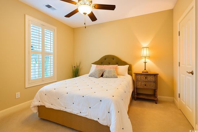 Bedroom with light carpet and ceiling fan | Image 24