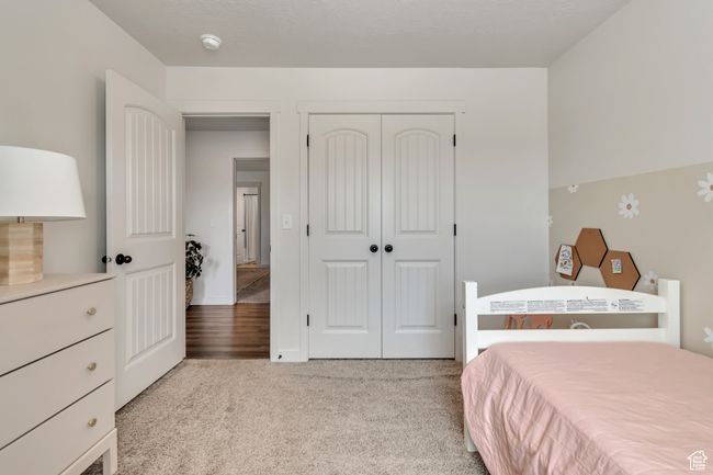 Carpeted bedroom with a closet | Image 15