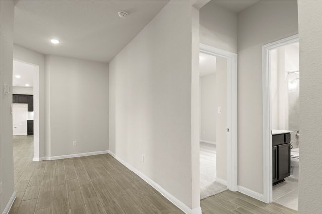 Corridor with light wood-style floors and recessed lighting | Image 5