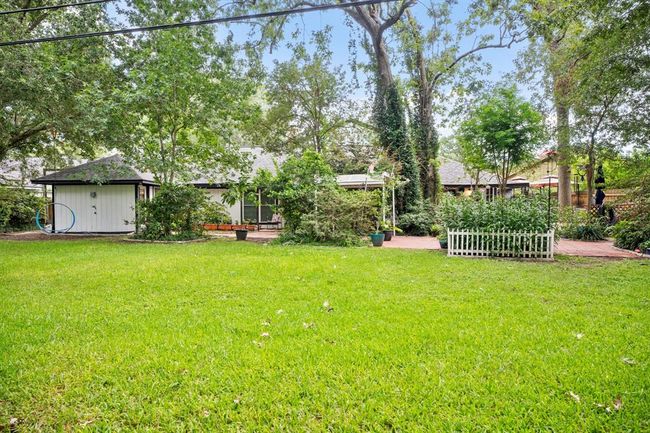 Welcome to your own slice of paradise! Lush trees and landscaping, ample green space, an expansive patio and more. | Image 28