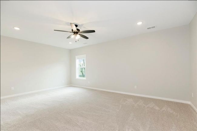 Unfurnished room featuring ceiling fan, light colored carpet, baseboards, and recessed lighting | Image 17