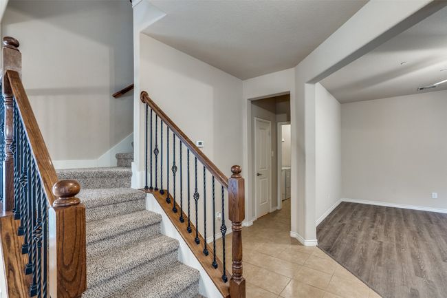 Stairway with baseboards, and tile flooring | Image 13