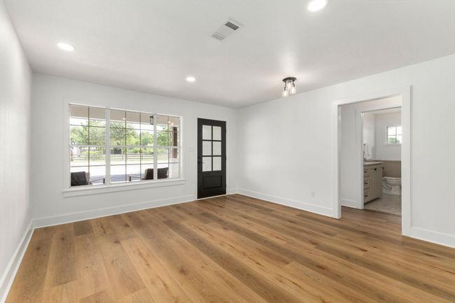 Versatile space perfect for a home office or dining area, featuring abundant natural light and elegant flooring. | Image 33