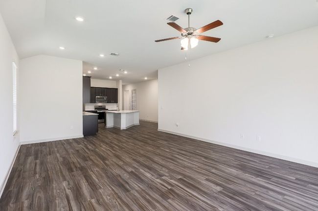Living room featuring ceiling fan, dark wood-style flooring, recessed lighting, and lofted ceiling | Image 5