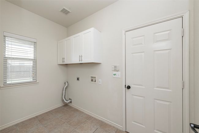 Laundry room with cabinets | Image 27