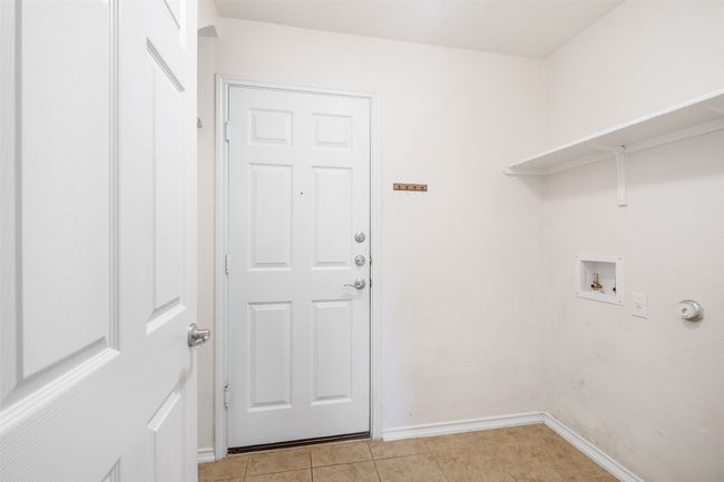 Laundry area featuring baseboards, washer hookup, light tile patterned floors, and laundry area | Image 18