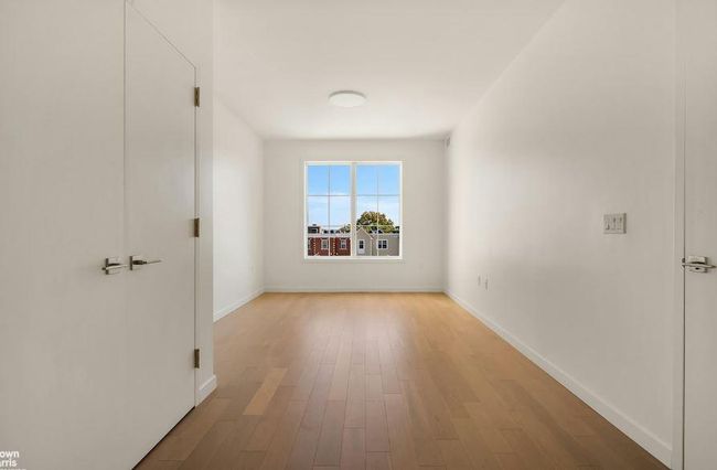 Spare room with wood finished floors and baseboards | Image 9