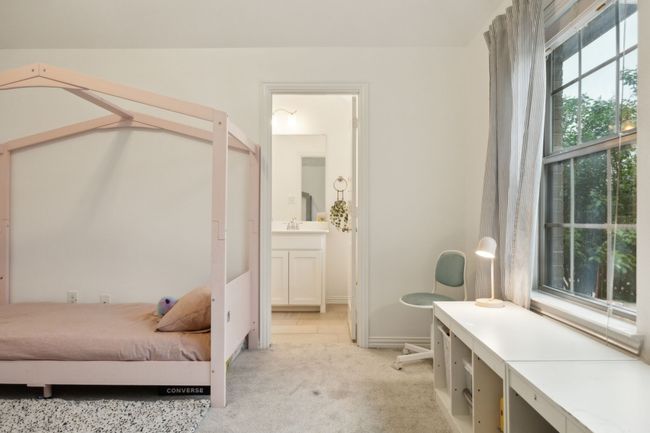 Bedroom with baseboards, light carpet, ensuite bath, and a sink | Image 16