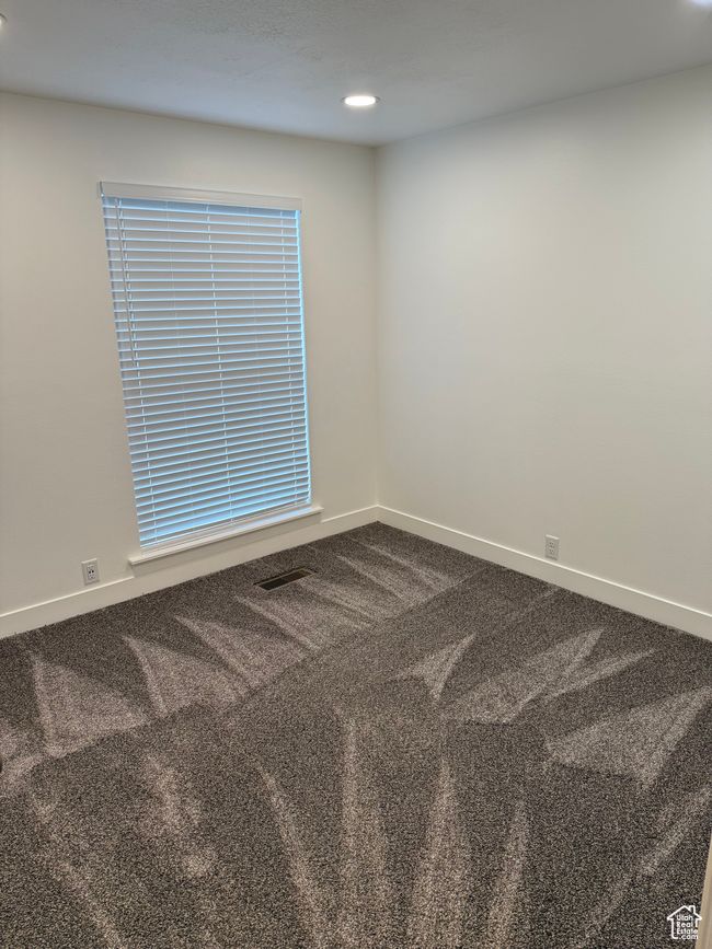 Unfurnished room with visible vents, baseboards, recessed lighting, and dark colored carpet | Image 10