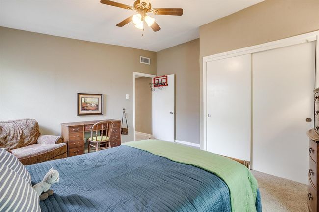 Carpeted bedroom featuring a closet and a ceiling fan | Image 21