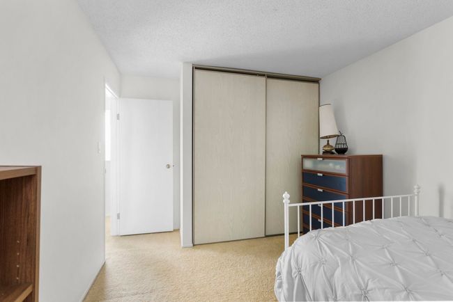 Bedroom featuring carpet, a textured ceiling, and a closet | Image 23