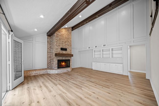 Brick fireplace with gas logs and additional shelves and cabinets | Image 18