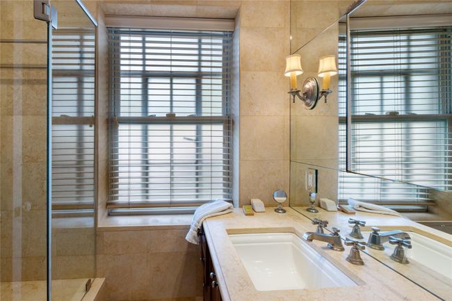 Bathroom featuring tile walls, vanity, and tiled shower | Image 15
