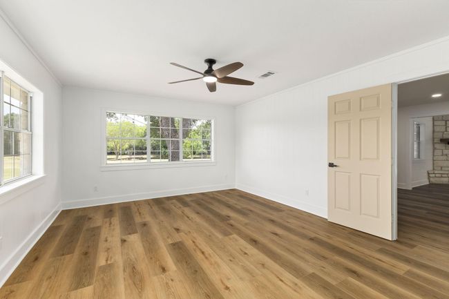 Spacious primary bedroom with serene pond views. | Image 21