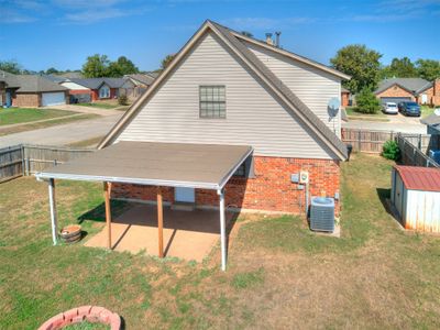 Rear view of house featuring a lawn and central AC unit | Image 2