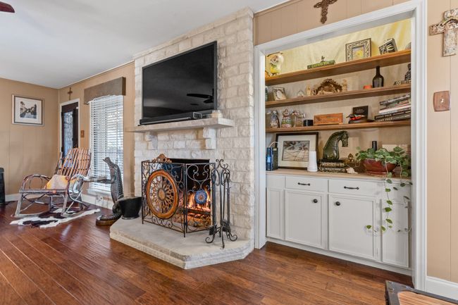 DEN with a stone fireplace and DRY BAR (plumbed), dark hardwood / wood-style floors | Image 12