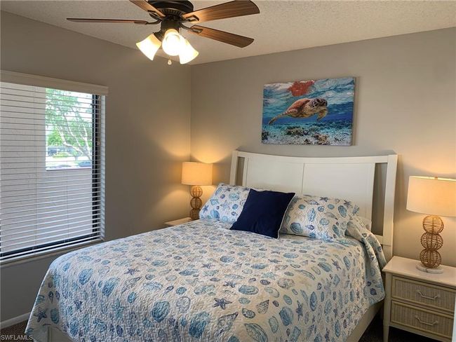 Bedroom featuring a ceiling fan, carpet, and a textured ceiling | Image 17