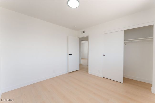 Unfurnished bedroom featuring light wood-type flooring and a closet | Image 45